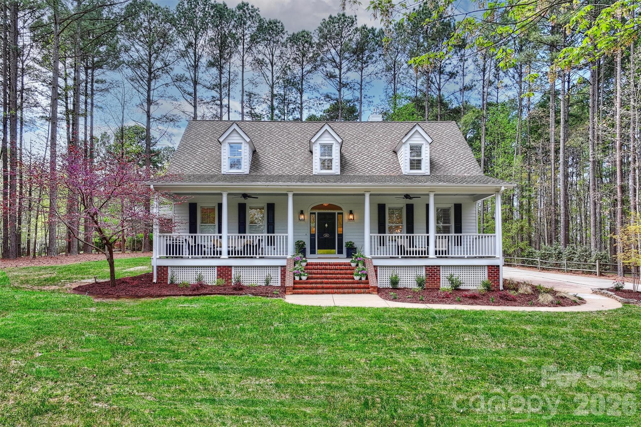 271 Beaten Path Road Mooresville, NC 28117 - Photo 2 of 47 a front view of a house with a yard table and chairs