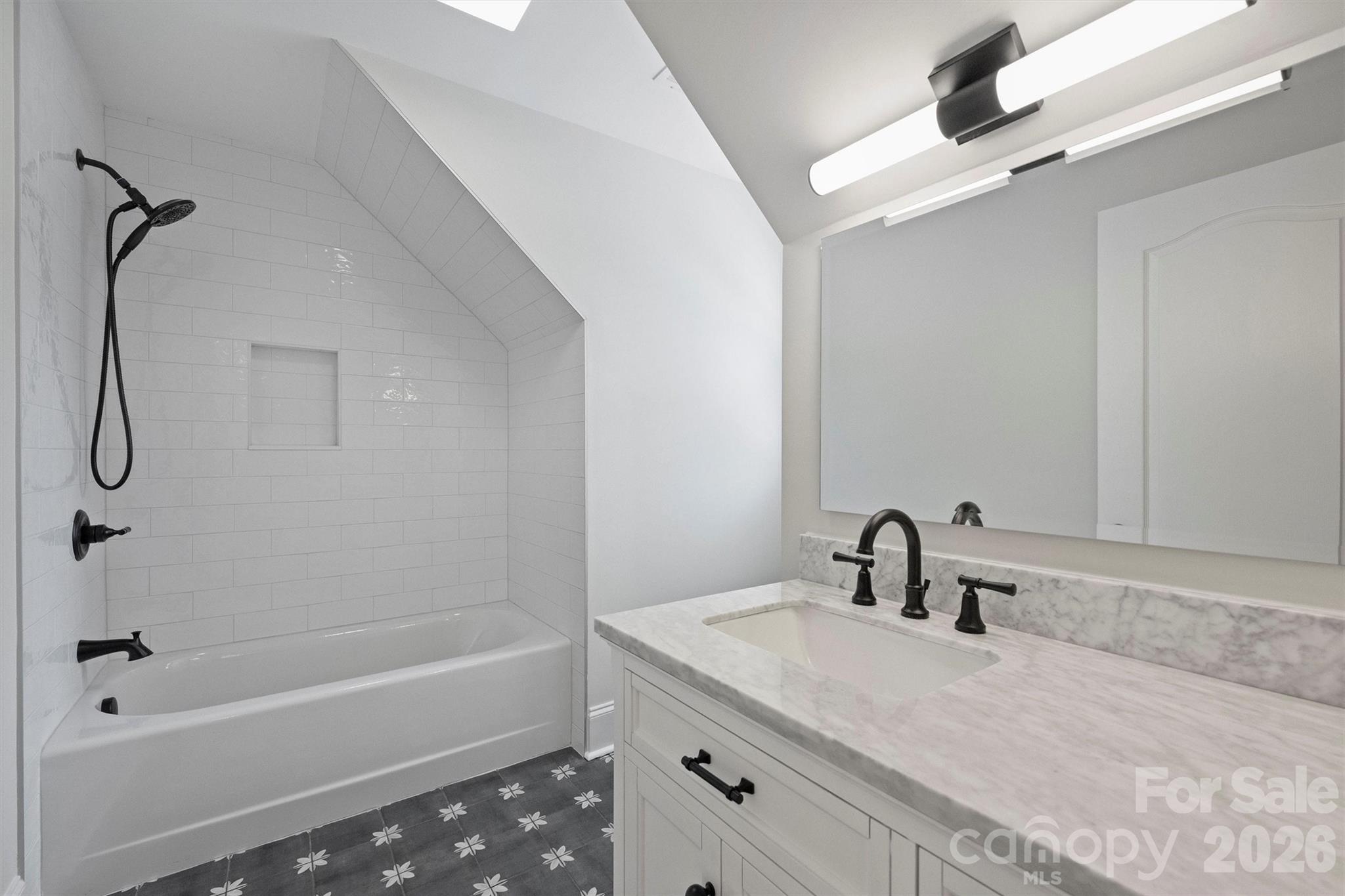271 Beaten Path Road Mooresville, NC 28117 - Photo 29 of 47 a bathroom with a granite countertop sink a mirror and a bathtub