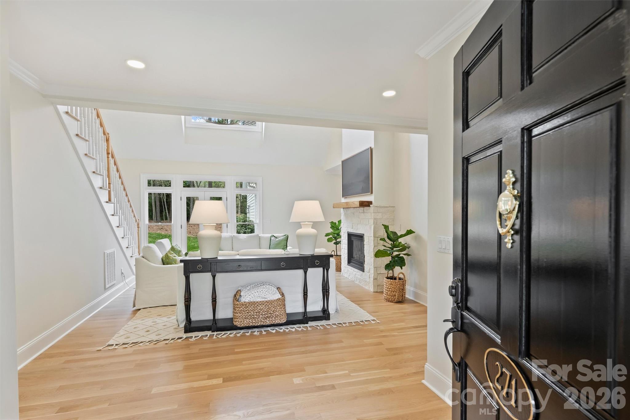 271 Beaten Path Road Mooresville, NC 28117 - Photo 8 of 47 a view of a hallway with wooden floor windows a fireplace and entryway