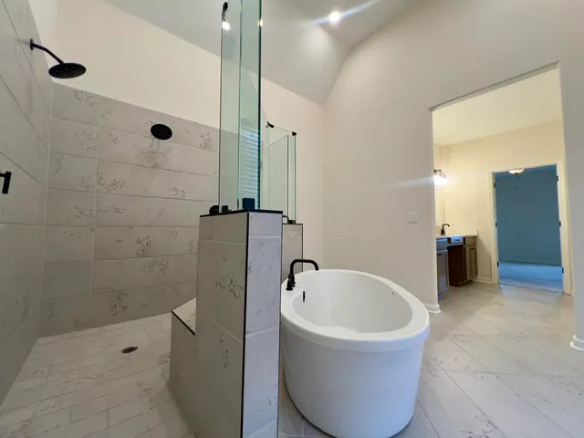 a bathroom with a bathtub and shower