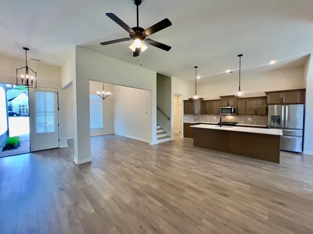 a view of kitchen with refrigerator microwave and stove