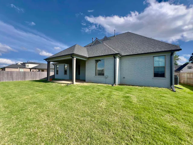a view of a house with a backyard