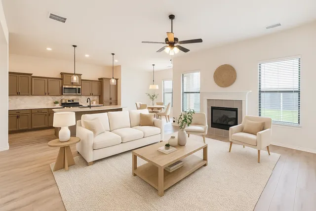 a living room with furniture a fireplace and a large mirror
