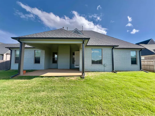 a view of a house with a yard and garage