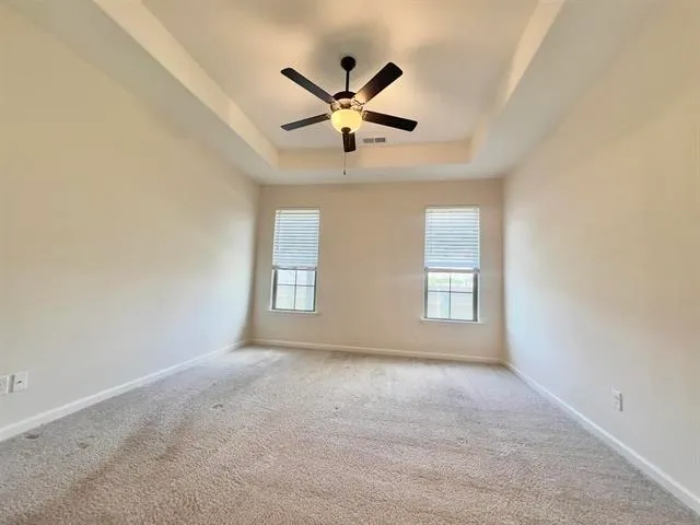 a view of empty room with ceiling fan