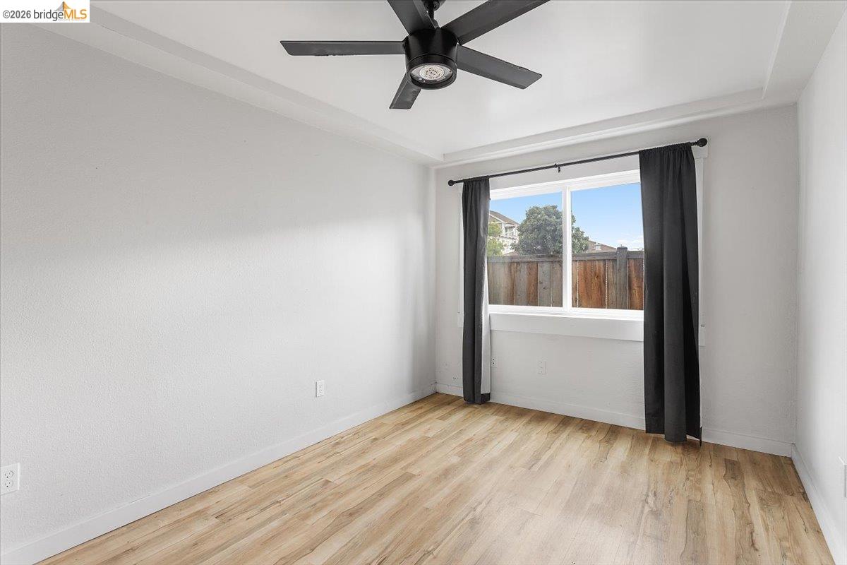 3029 Chestnut Street Oakland, CA 94608 - Photo 14 of 23 a view of an empty room with a window and wooden floor