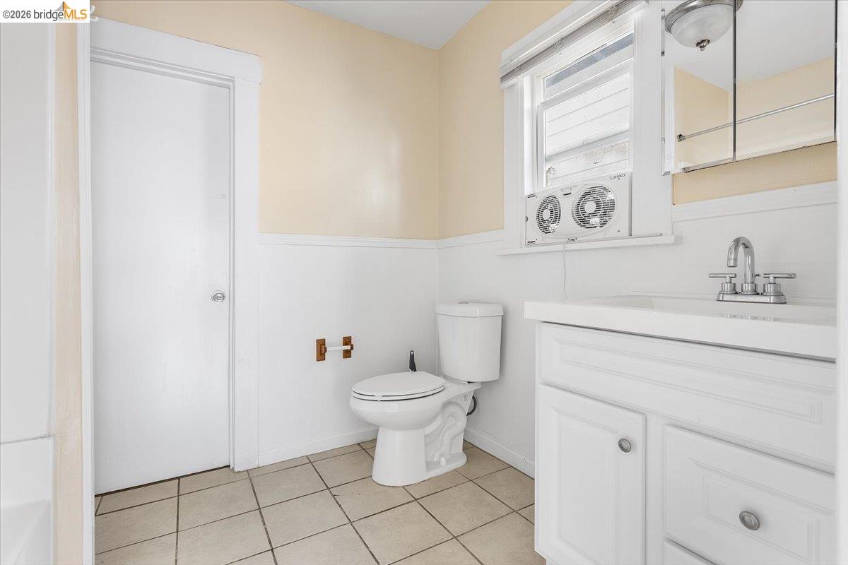 3029 Chestnut Street Oakland, CA 94608 - Photo 17 of 23 a bathroom with a toilet sink and mirror