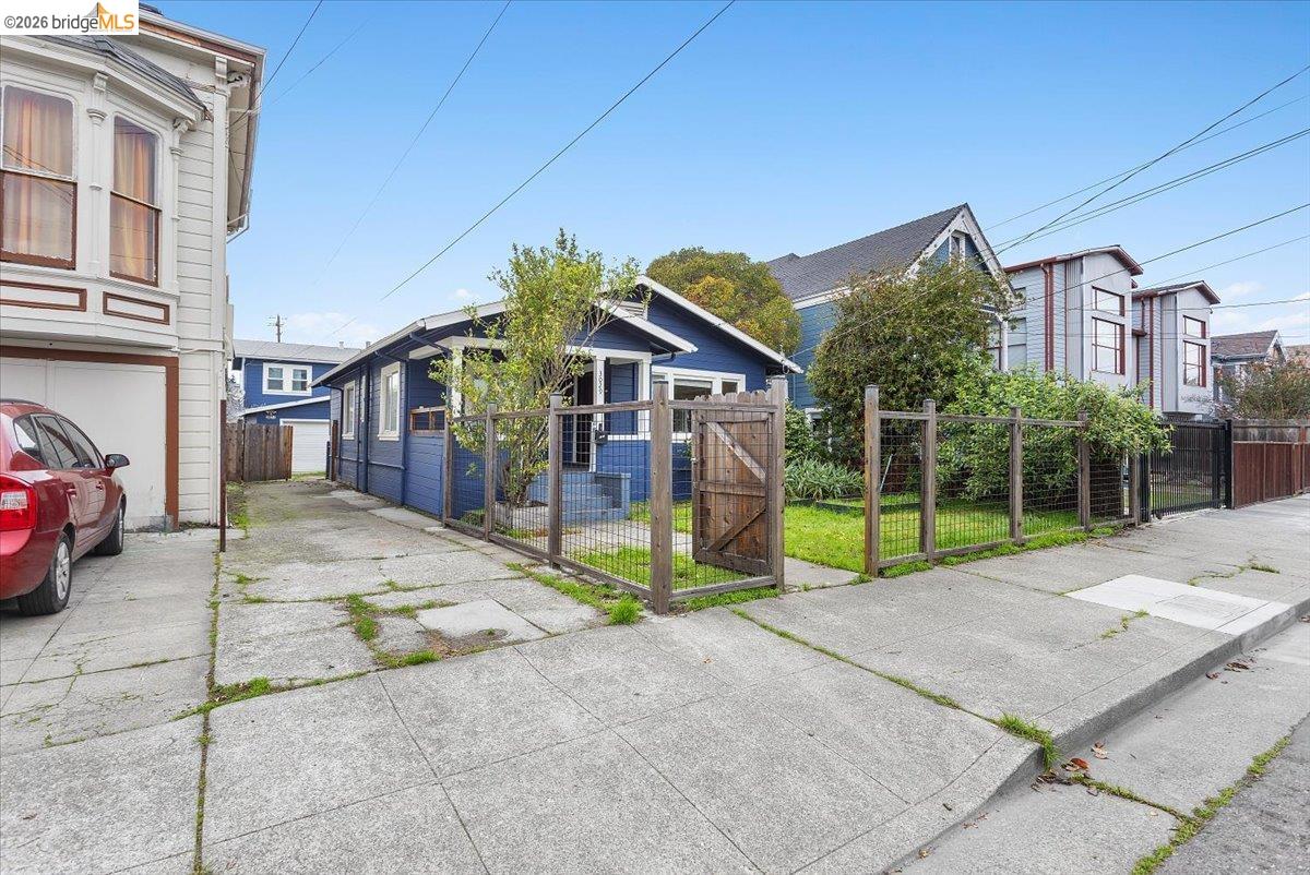 3029 Chestnut Street Oakland, CA 94608 - Photo 2 of 23 a view of a house with a patio and a yard