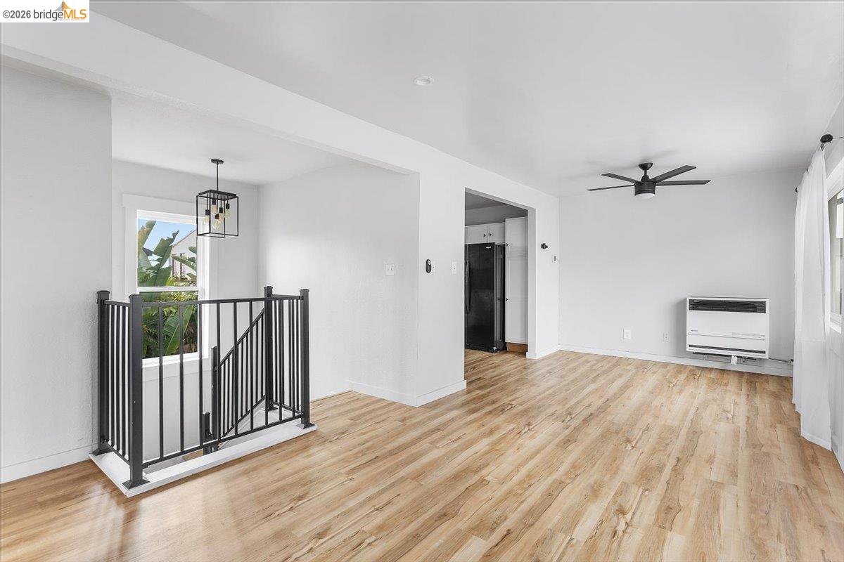 3029 Chestnut Street Oakland, CA 94608 - Photo 10 of 23 a view of a hallway with wooden floor and staircase