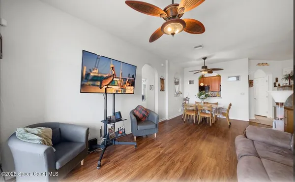 a living room with furniture a rug and a chandelier