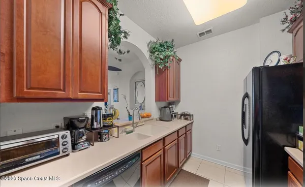 a kitchen with stainless steel appliances a sink cabinets and a refrigerator