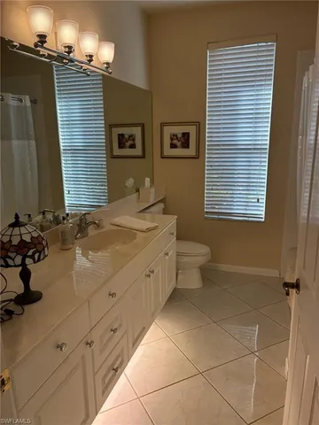 a living room with furniture a fireplace and a large window