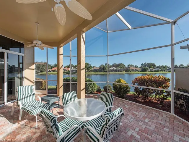 a balcony with furniture and a potted plant
