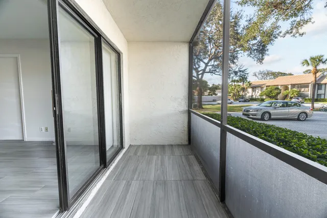 a view of a balcony with wooden floor