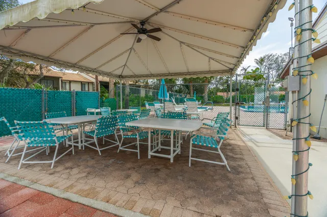 a view of a table and chairs under an umbrella