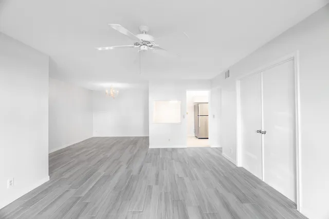 a view of a room with wooden floor and white walls