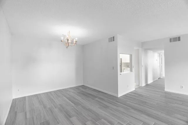 a view of a room with wooden floor