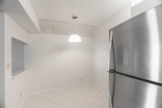 a view of a refrigerator in kitchen