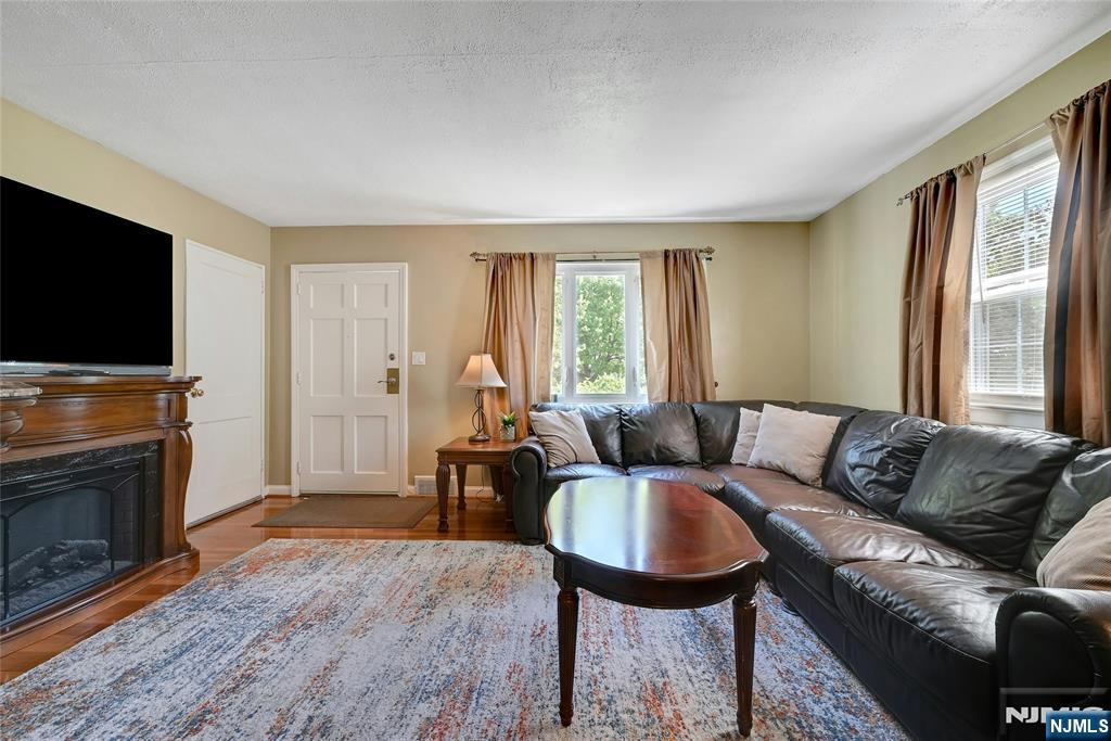 85 Edison Street Clifton, NJ 07013 - Photo 4 of 28 a living room with furniture a flat screen tv and a fireplace