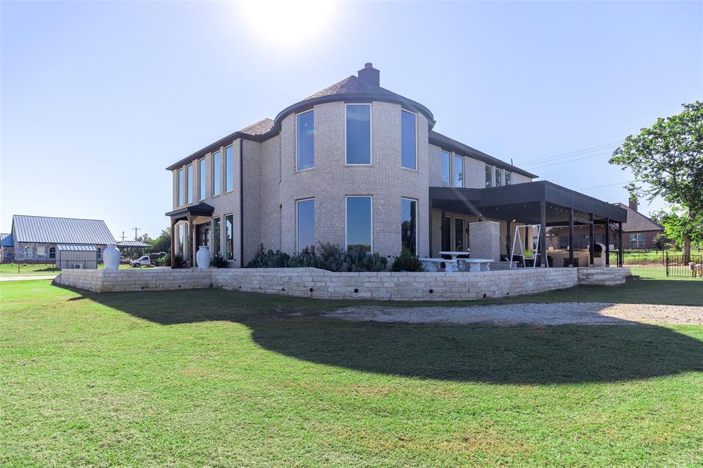 2630 Rockhill Road Aubrey, TX 76227 - Photo 6 of 36 a front view of a house with a garden and plants