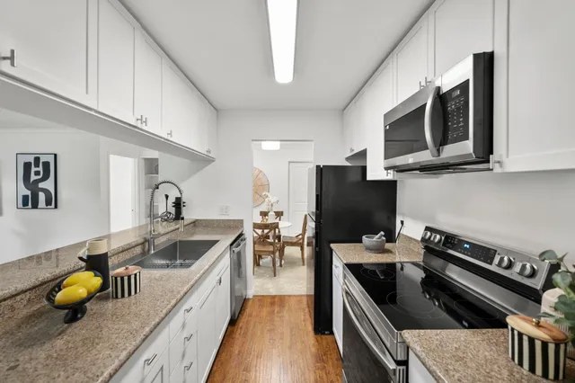 a kitchen with a sink a counter and cabinets