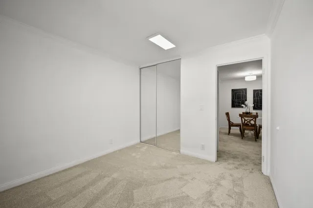 an empty room with closet and a bathroom