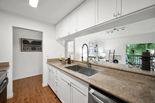 a kitchen with sink and natural light