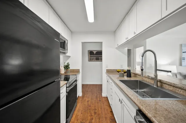 a kitchen with a sink stove and refrigerator