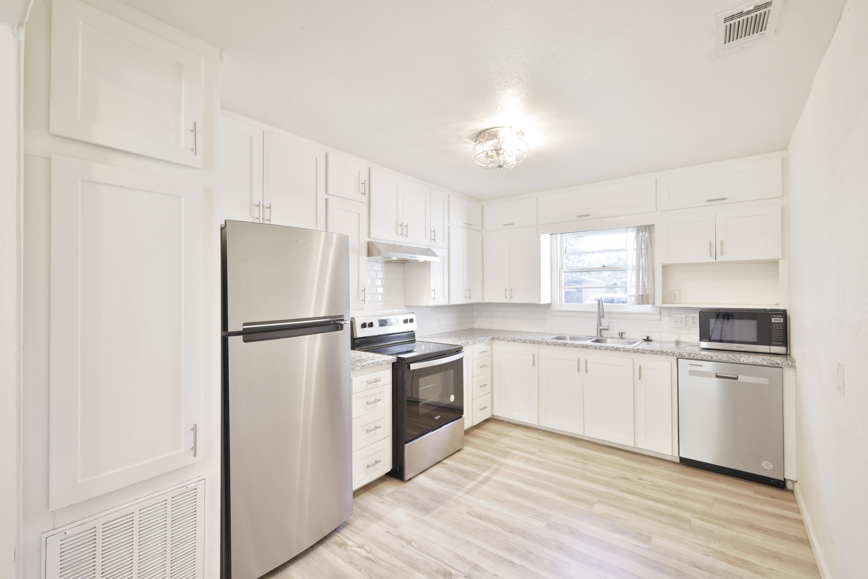3812 31st Street Lubbock, TX 79410 - Photo 1 of 16 a kitchen with white cabinets and white appliances