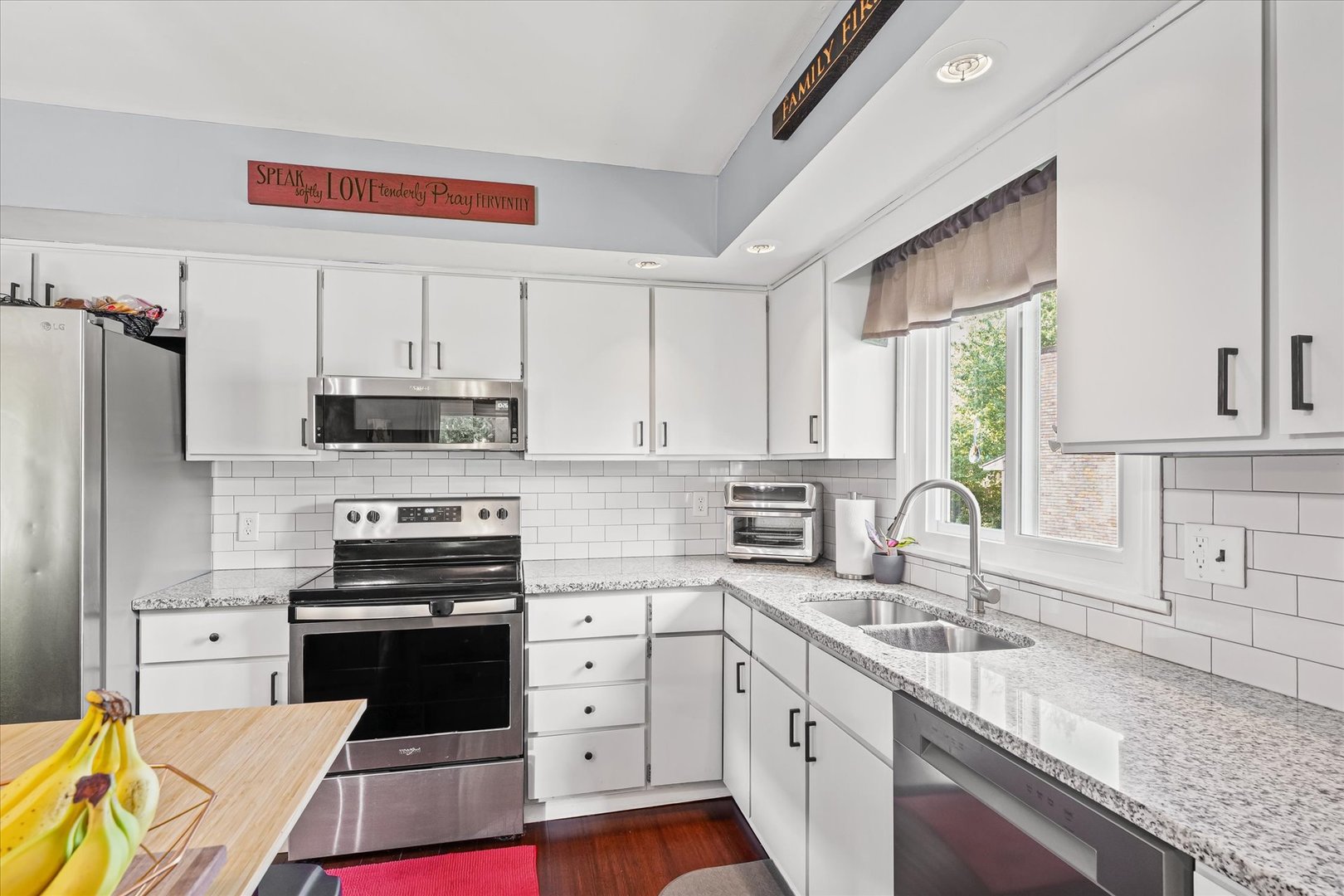 1011 Harrington Drive Champaign, IL 61821 - Photo 11 of 37 a kitchen with stainless steel appliances a stove sink and cabinets