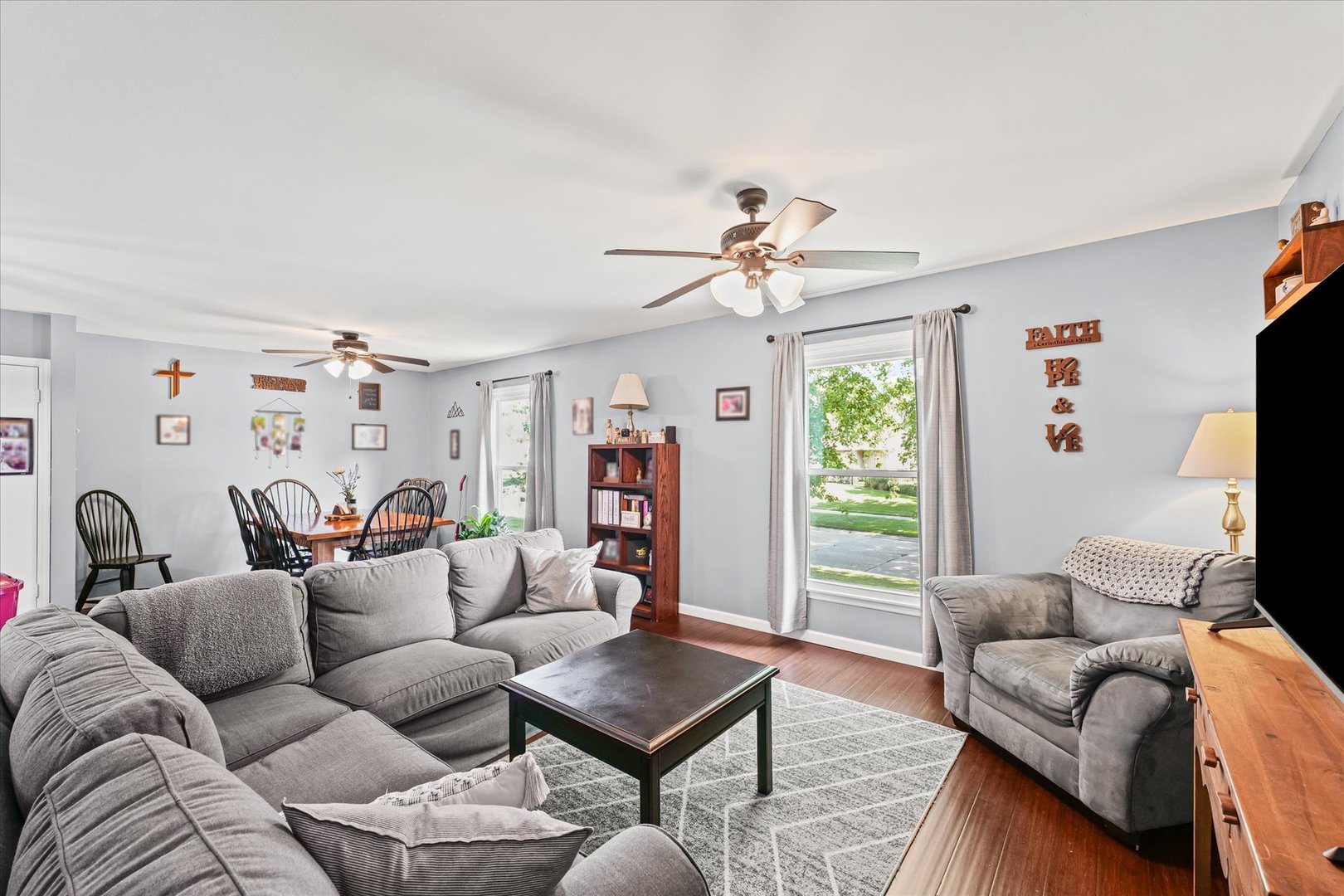 1011 Harrington Drive Champaign, IL 61821 - Photo 4 of 37 a living room with furniture a flat screen tv and a window