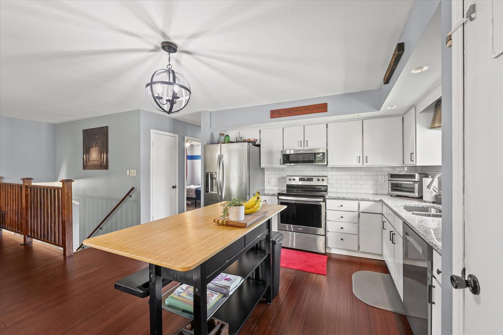 1011 Harrington Drive Champaign, IL 61821 - Photo 10 of 37 a kitchen with stainless steel appliances a dining table chairs stove refrigerator and microwave