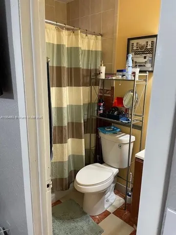 a white toilet sitting next to a bathroom sink
