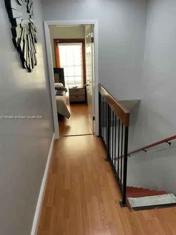 a view of entryway and hall with wooden floor