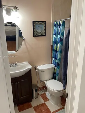a bathroom with a toilet a sink and mirror
