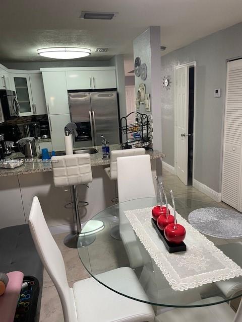 8340 Northwest 8th Street, Unit N12 Miami, FL 33126 - Photo 8 of 21 a living room with furniture and a large window