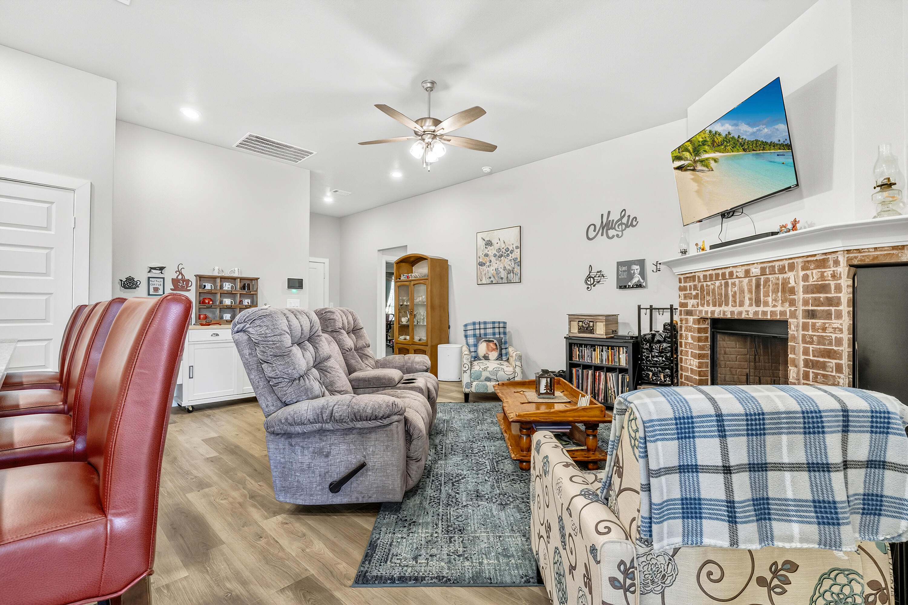7231 29th Street Lubbock, TX 79407 - Photo 12 of 23 a living room with furniture a flat screen tv and a fireplace
