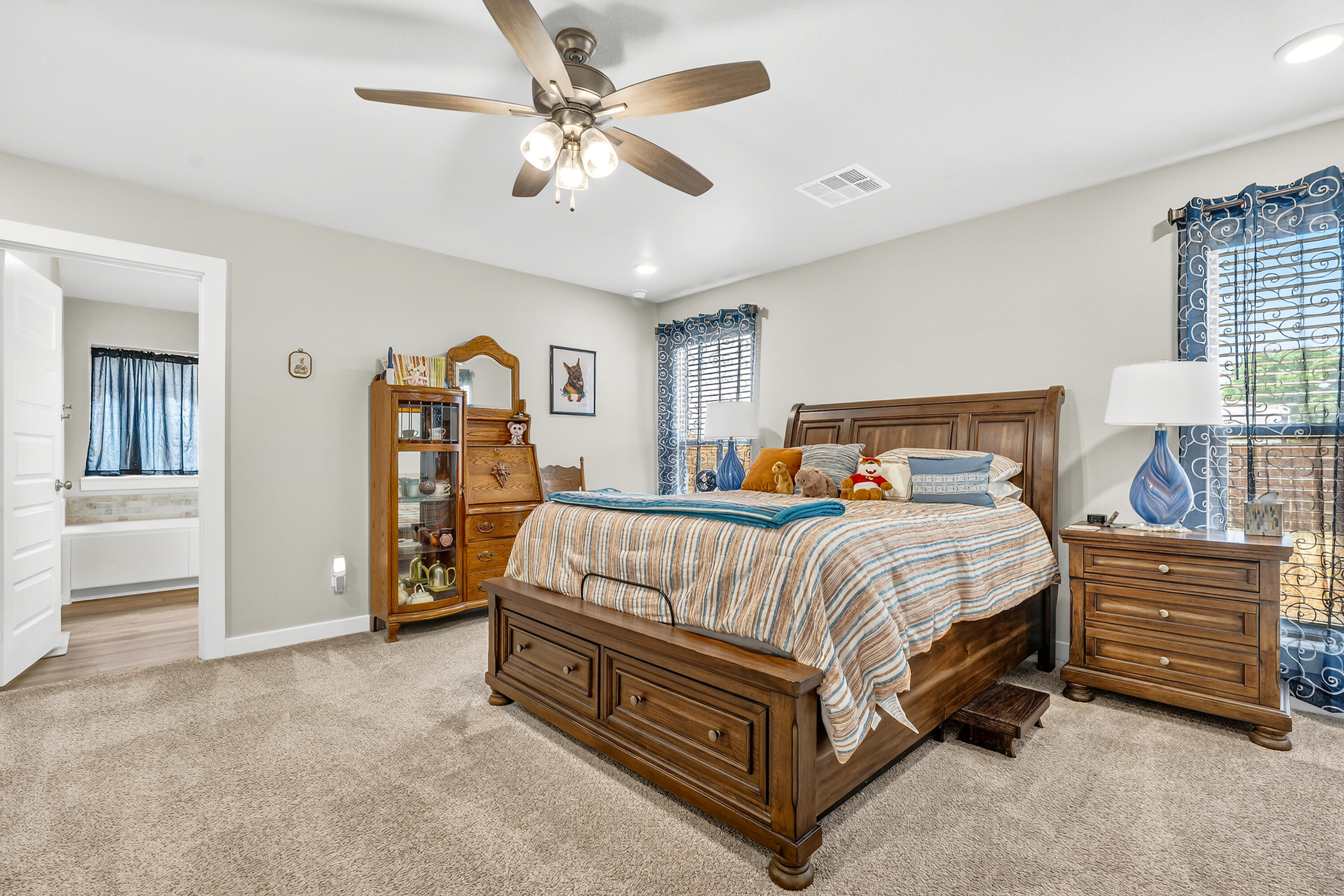 7231 29th Street Lubbock, TX 79407 - Photo 17 of 23 a bedroom with a bed and a chandelier