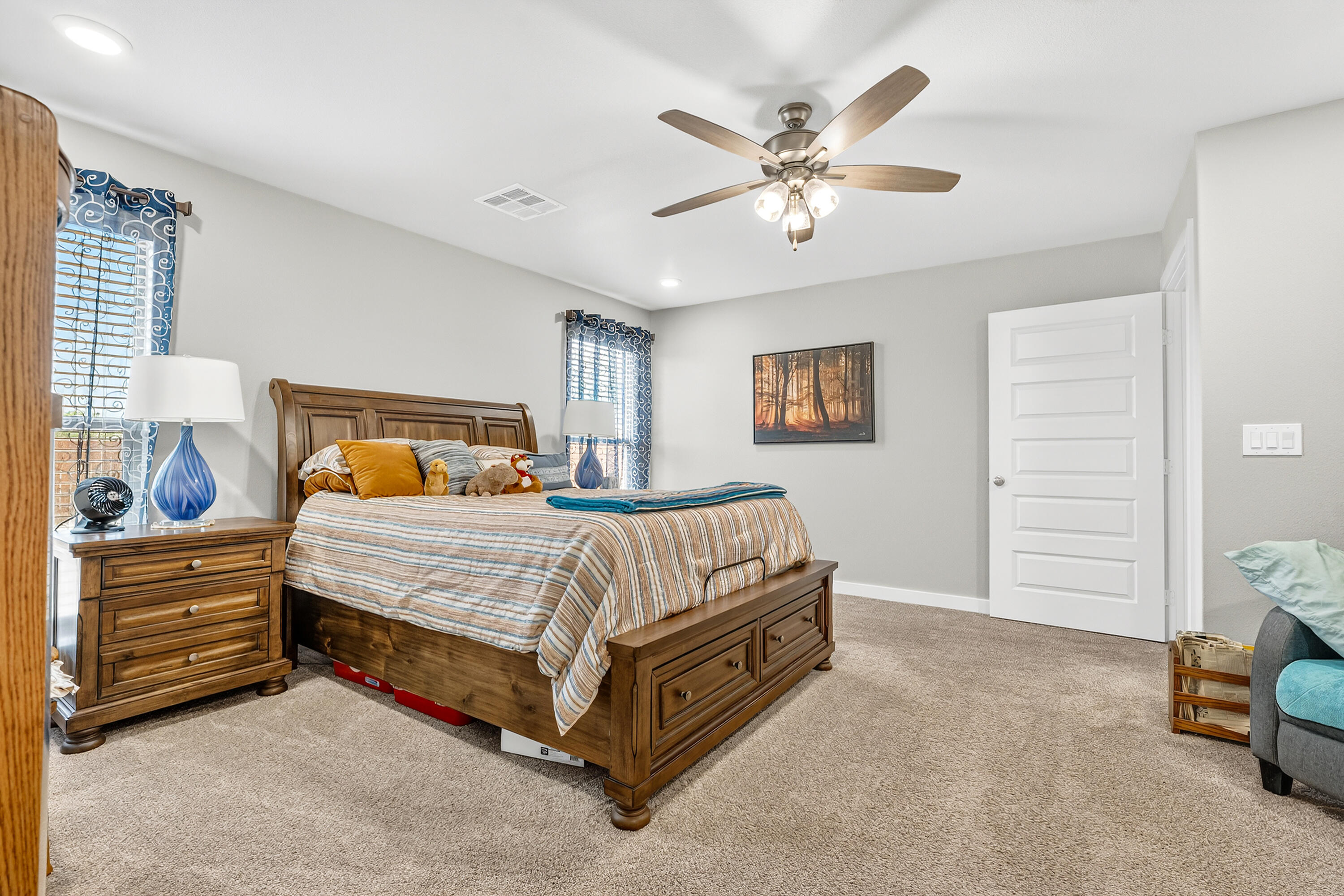 7231 29th Street Lubbock, TX 79407 - Photo 18 of 23 a bedroom with a bed and a chandelier
