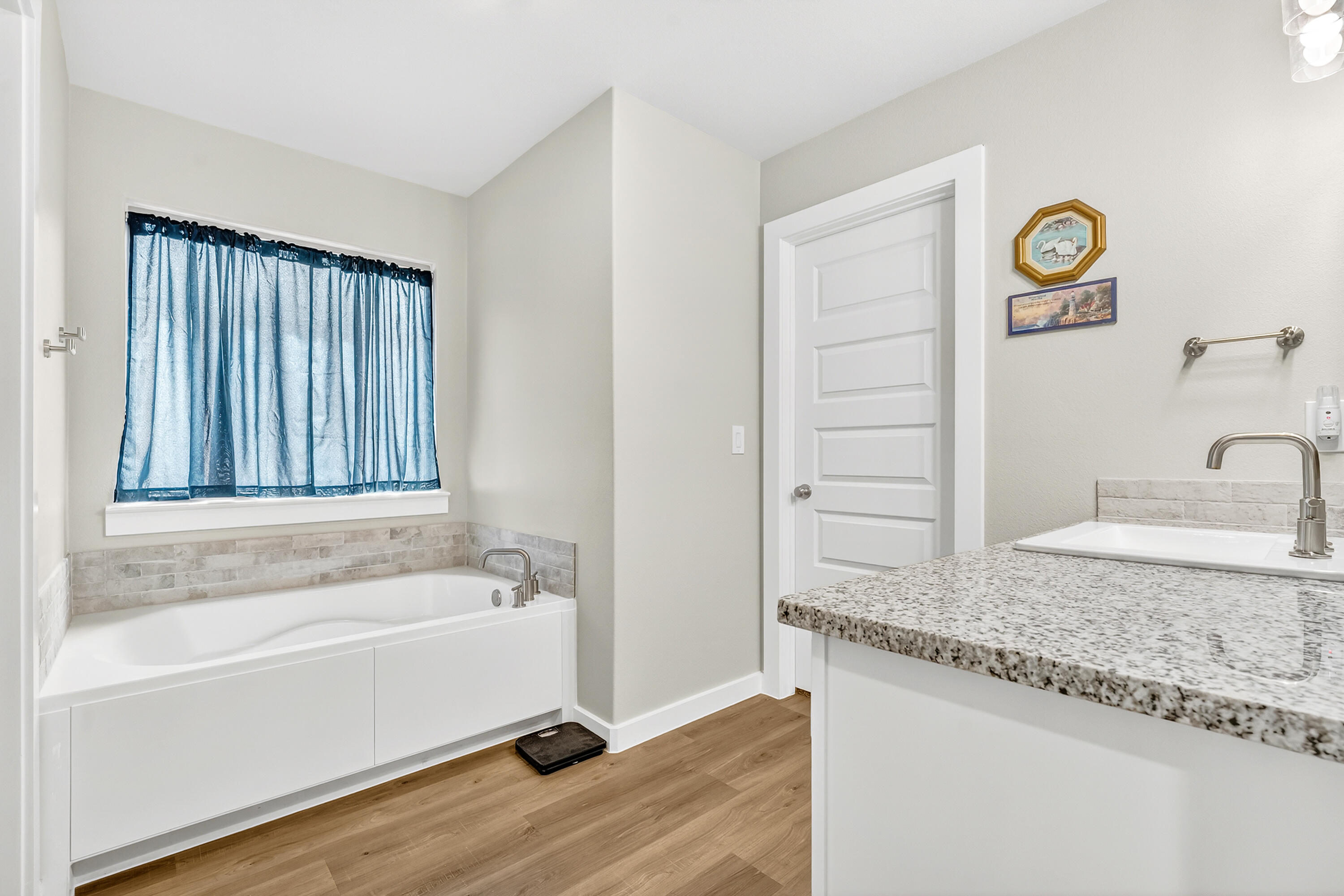 7231 29th Street Lubbock, TX 79407 - Photo 19 of 23 a bathroom with a granite countertop tub sink and mirror