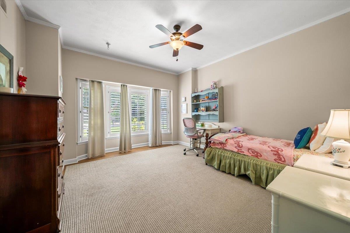1273 Brookfield Road Memphis, TN 38119 - Photo 26 of 40 Spacious room with a neutral color palette, featuring a ceiling fan, recessed lighting, and a multi-pane window array with plantation shutters