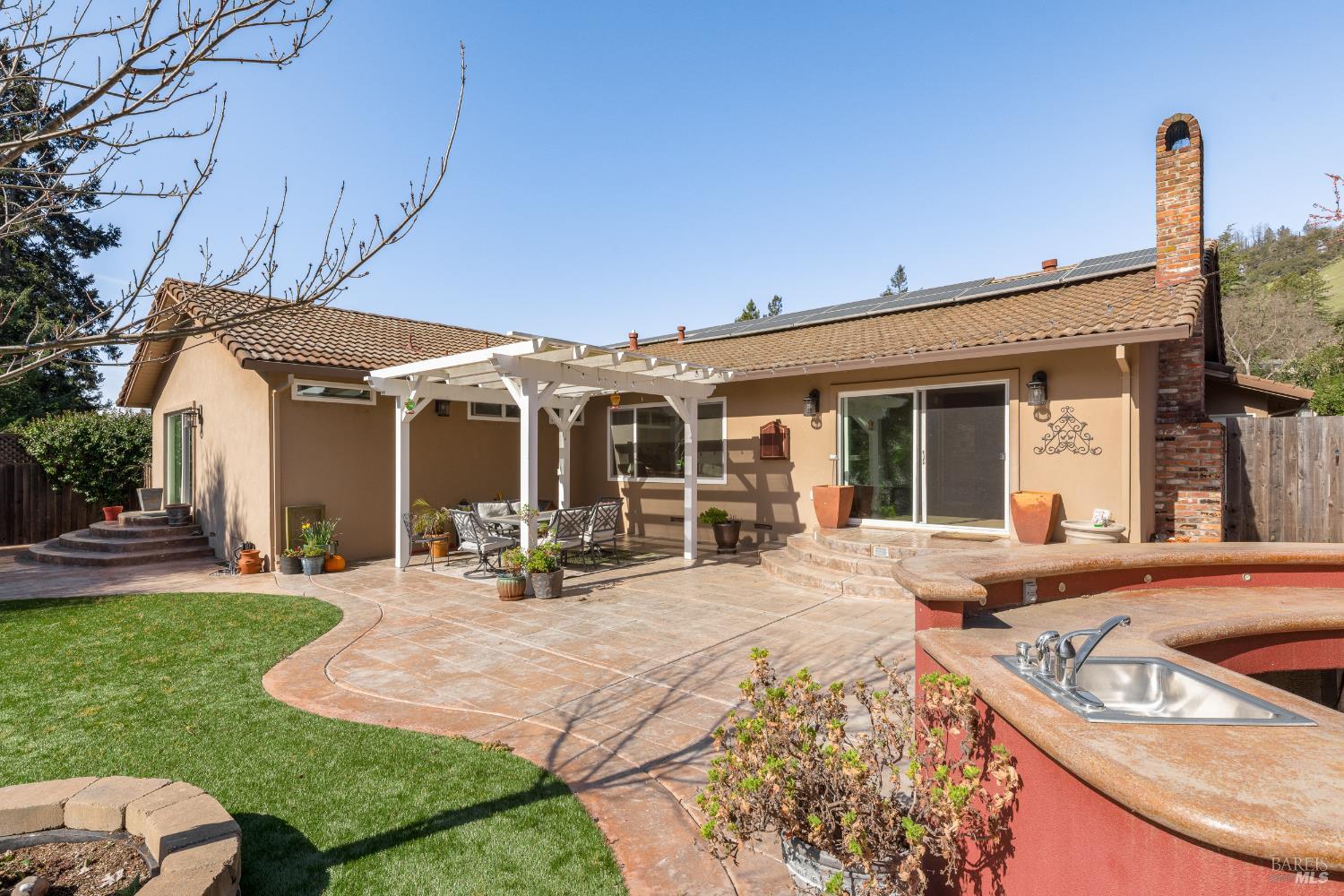 5960 Yerba Buena Road Santa Rosa, CA 95409 - Photo 12 of 17 a view of a house with backyard sitting area and garden