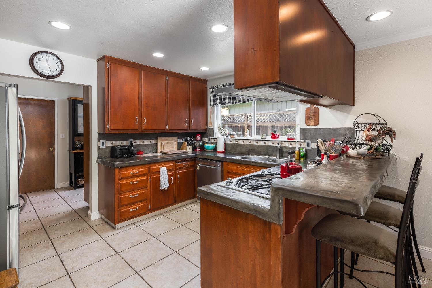 5960 Yerba Buena Road Santa Rosa, CA 95409 - Photo 3 of 17 a kitchen with stainless steel appliances granite countertop wooden cabinets a refrigerator and a stove