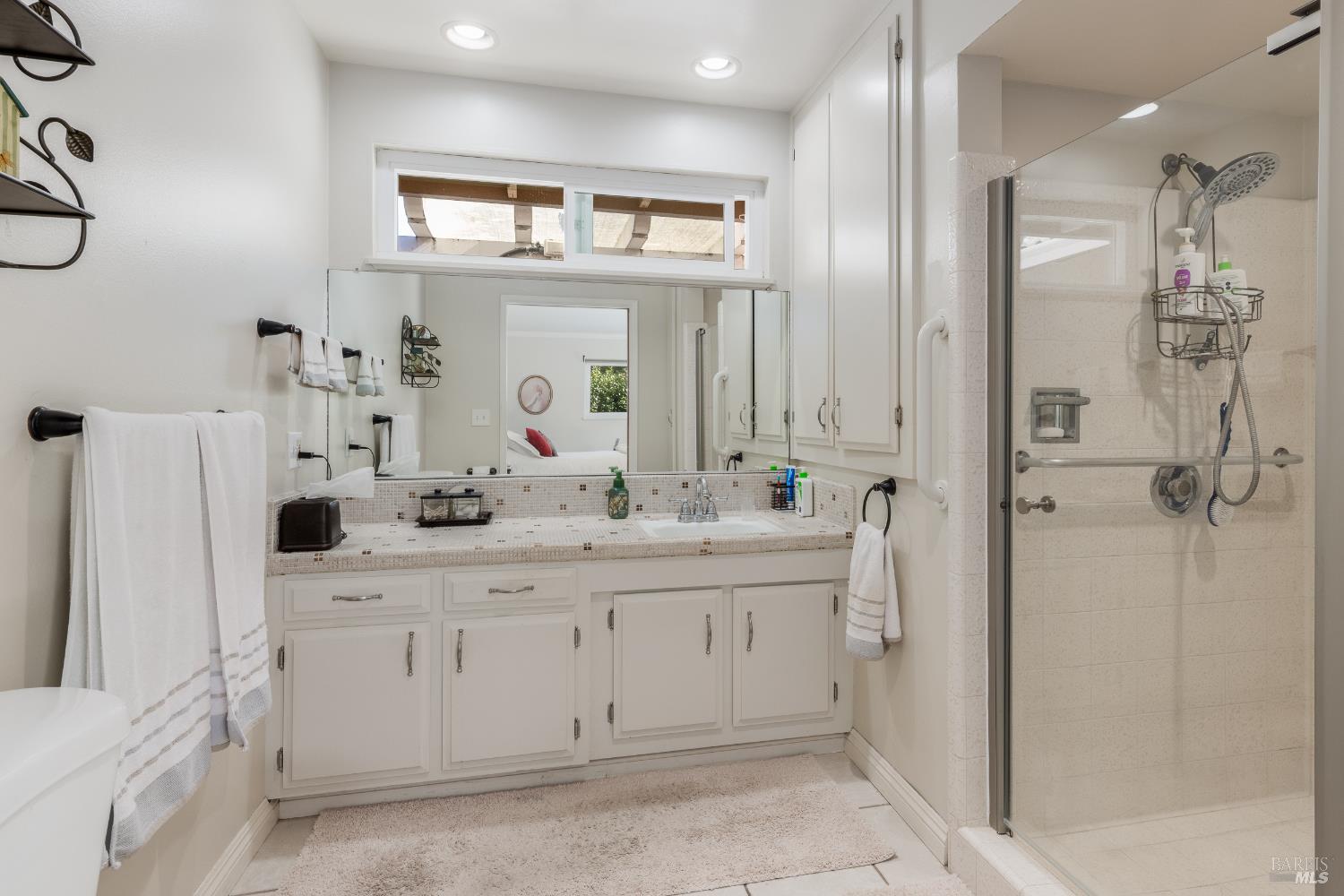 5960 Yerba Buena Road Santa Rosa, CA 95409 - Photo 9 of 17 a bathroom with a granite countertop sink a mirror and a shower
