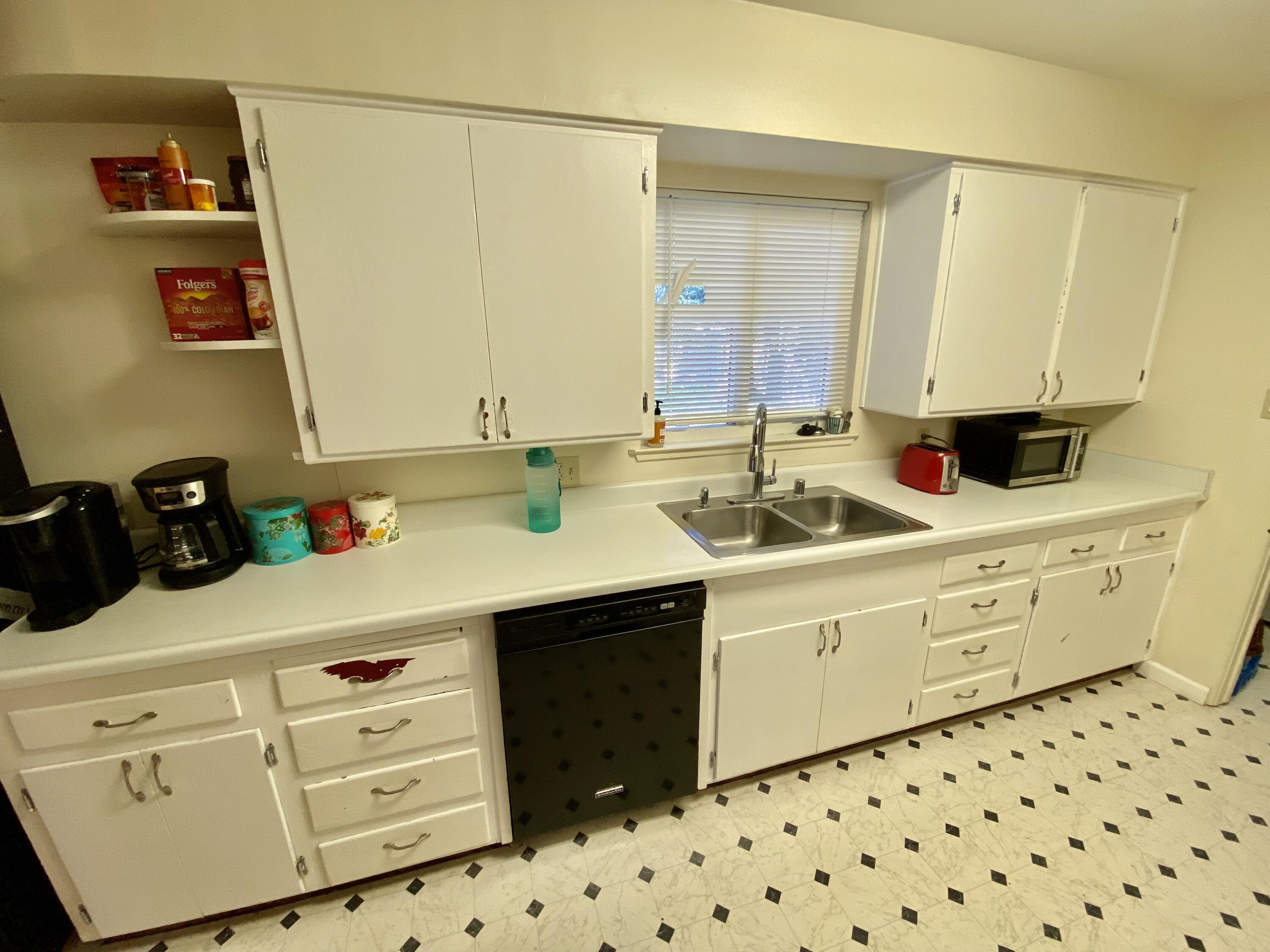 2890 Irwin Road Redding, CA 96002 - Photo 12 of 28 a kitchen with white cabinets and sink