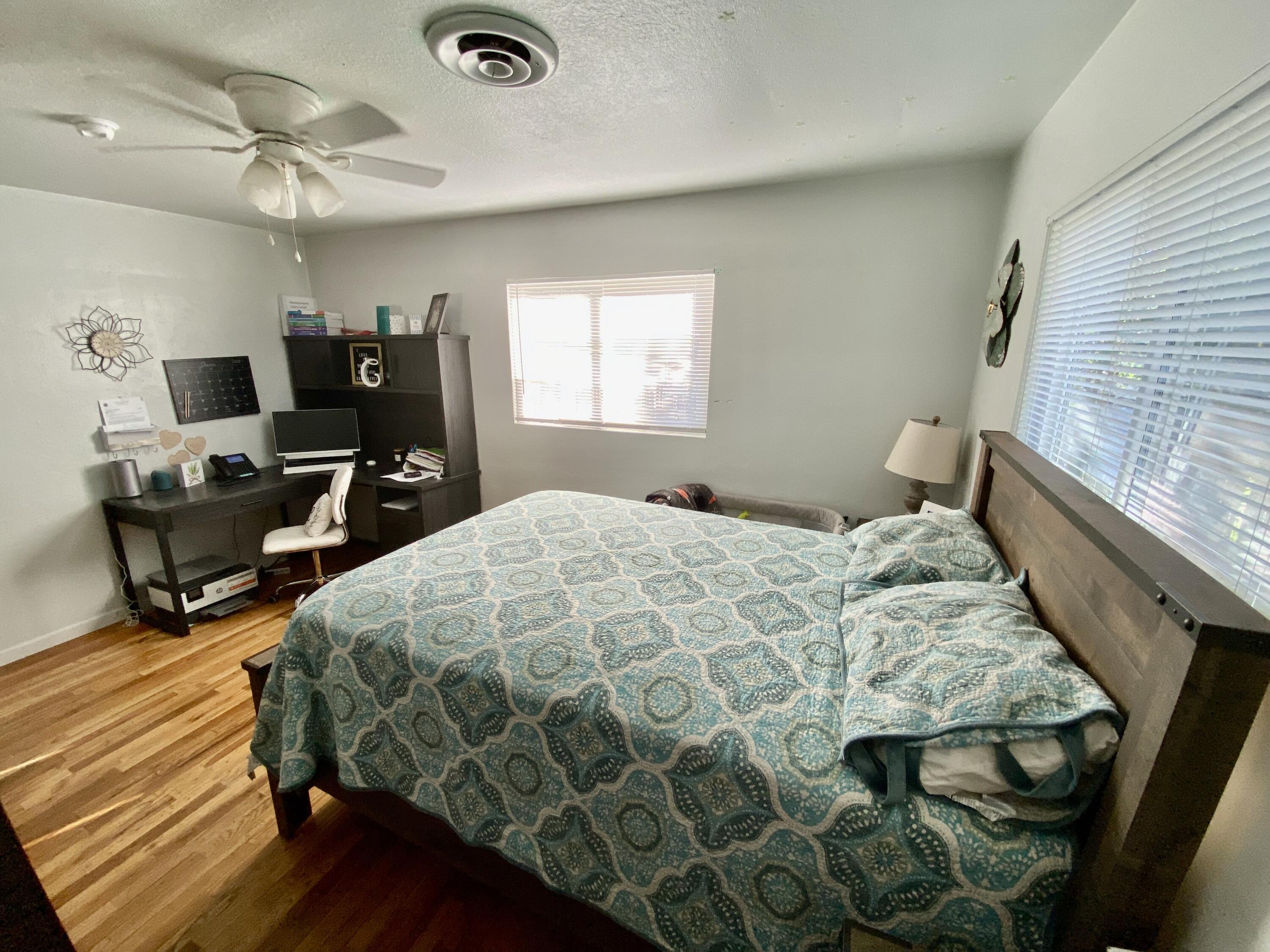 2890 Irwin Road Redding, CA 96002 - Photo 14 of 28 a bedroom with a bed and wooden floor
