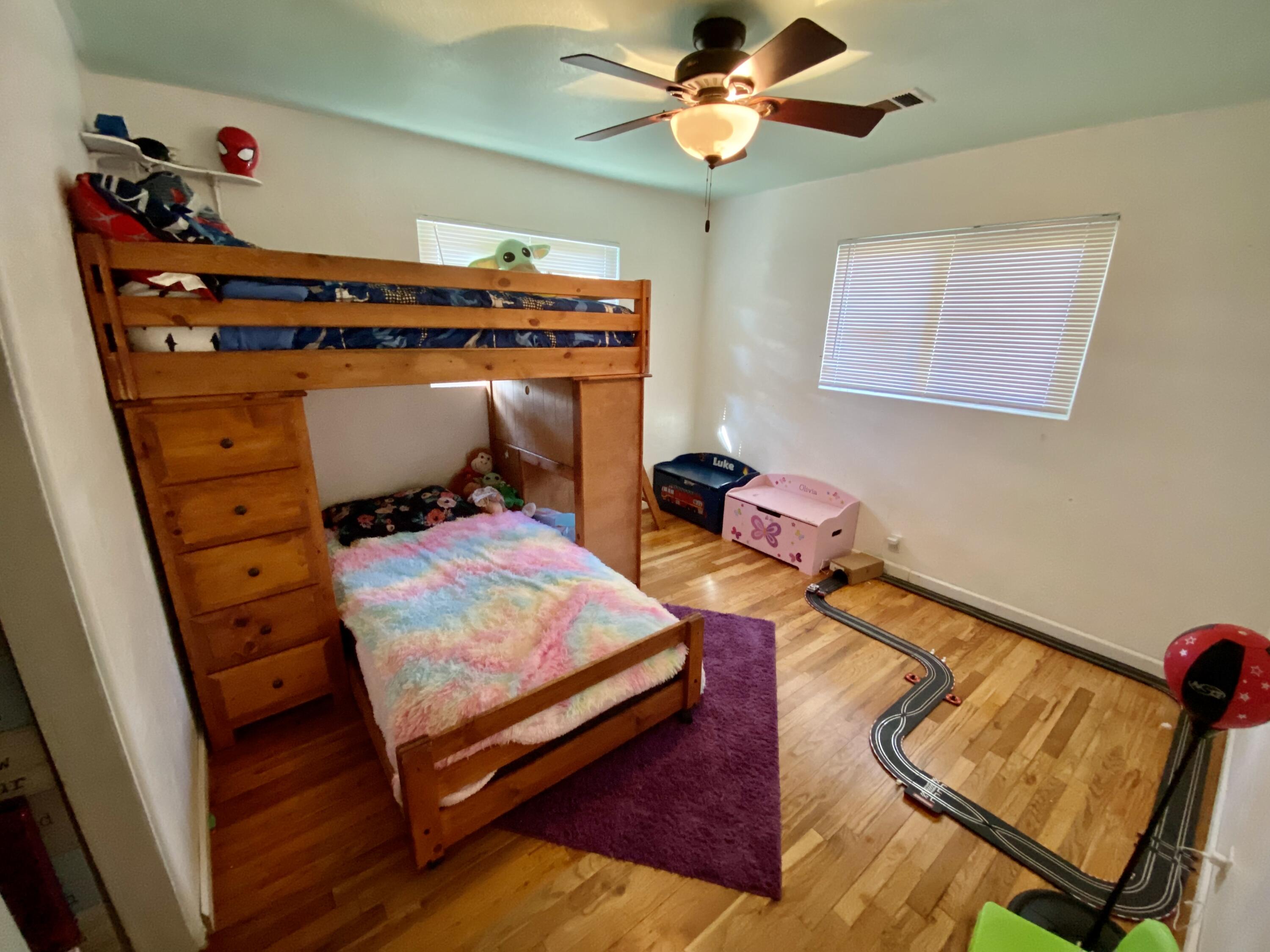 2890 Irwin Road Redding, CA 96002 - Photo 17 of 28 a bedroom with furniture and a wooden floor