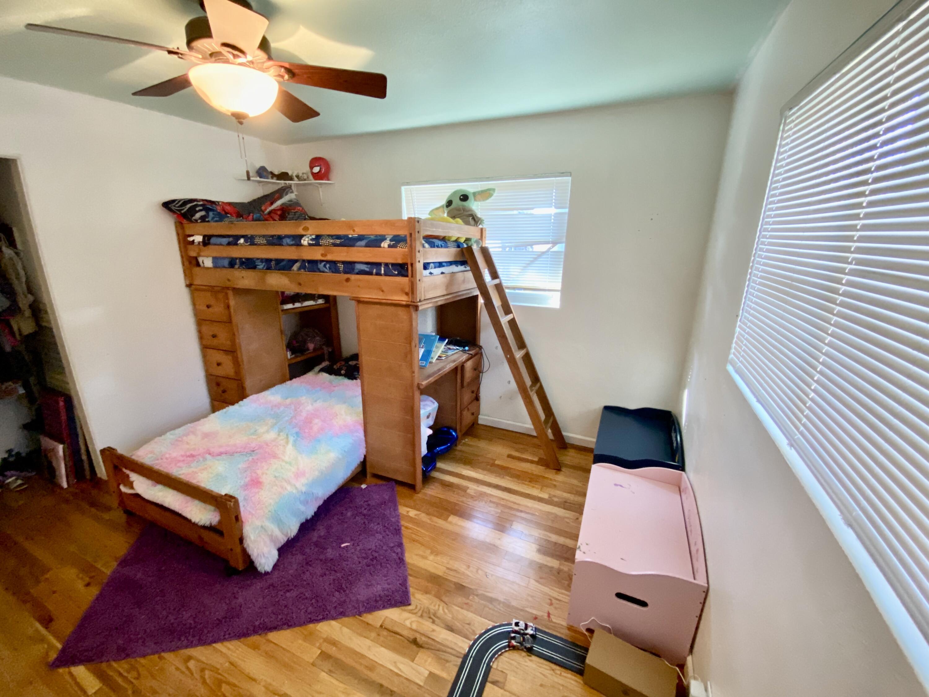 2890 Irwin Road Redding, CA 96002 - Photo 18 of 28 a bedroom with a bed and wooden floor