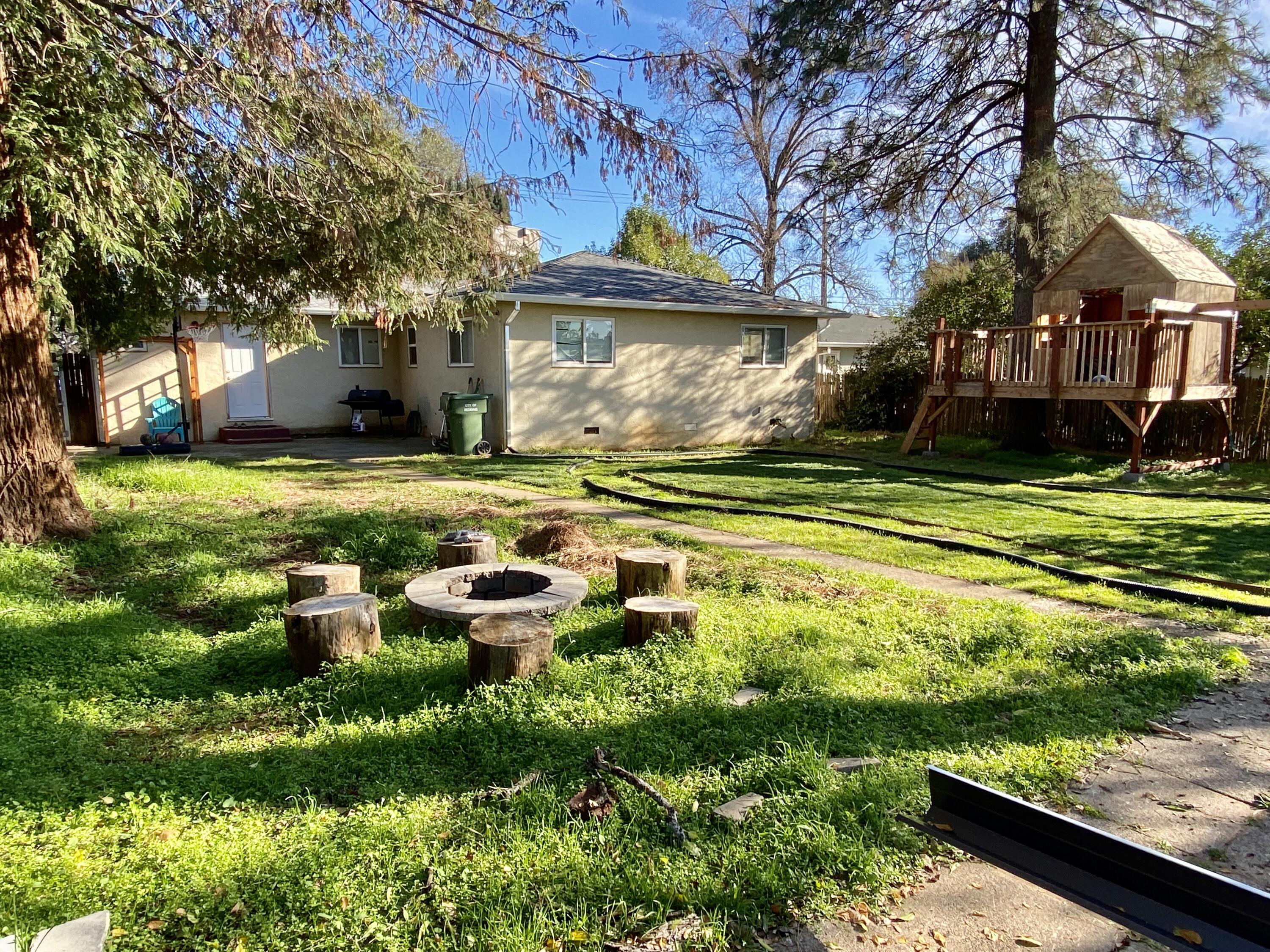2890 Irwin Road Redding, CA 96002 - Photo 23 of 28 a view of a house with a yard and sitting area