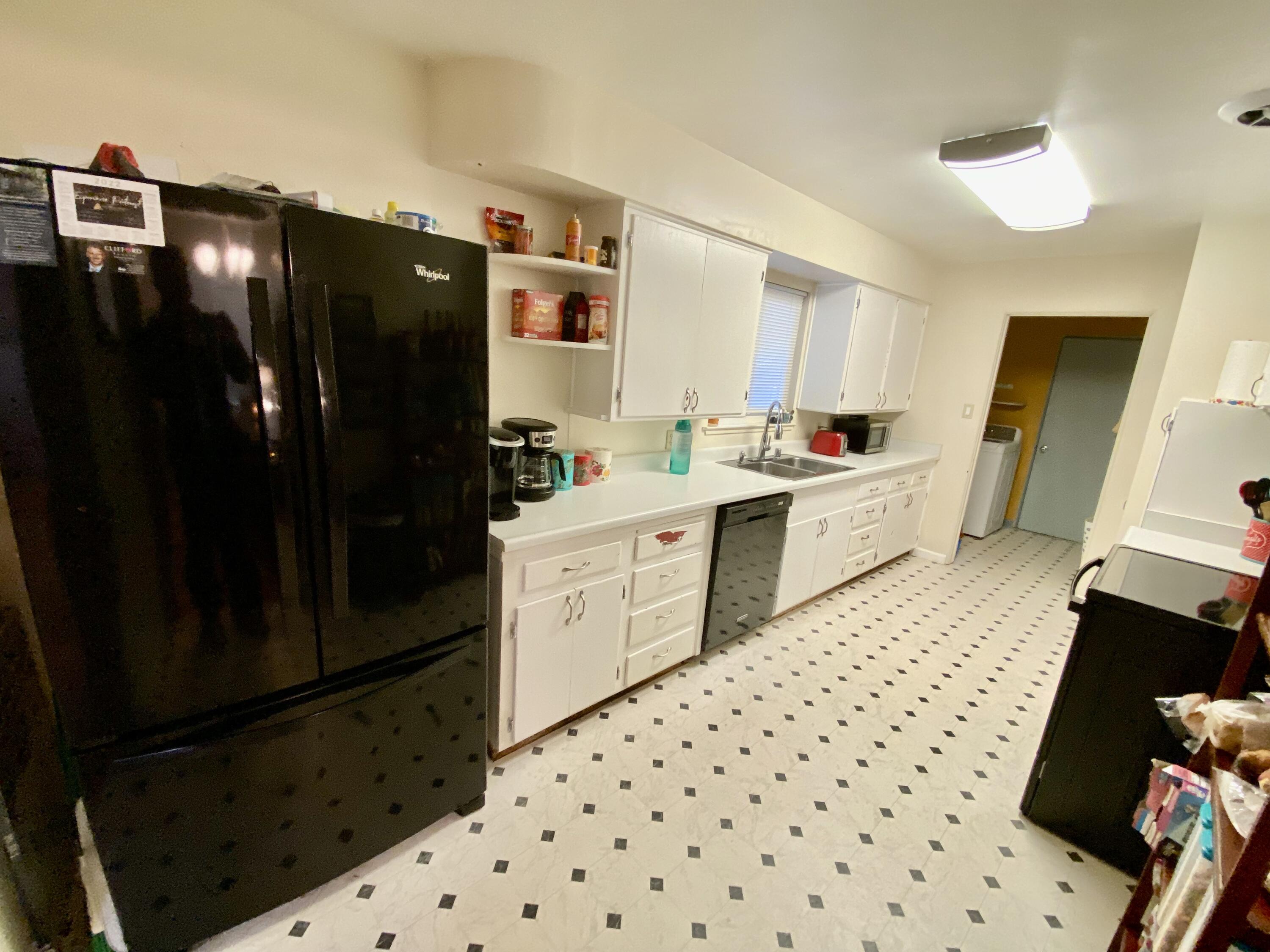 2890 Irwin Road Redding, CA 96002 - Photo 8 of 28 a kitchen with a sink a refrigerator and cabinets